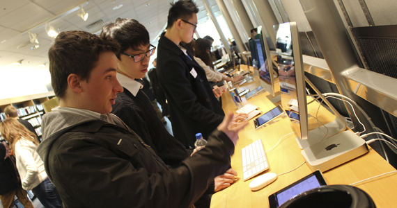 Students discussing at a a computer